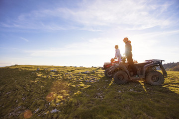 Couple driving off-road with quad bike or ATV © FS-Stock