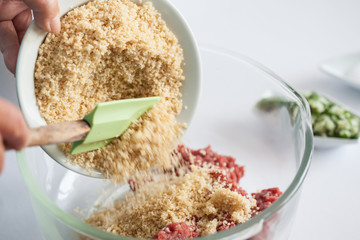Step by step Levantine cuisine kibbeh preparation : Adding the ingredients to prepare kibbeh into a bowl