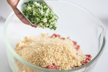 Step by step Levantine cuisine kibbeh preparation : Adding the ingredients to prepare kibbeh into a bowl