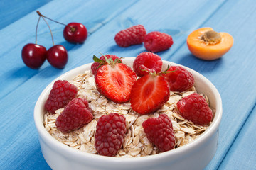 Oat flakes with fruits in glass bowl, healthy lifestyle and nutrition