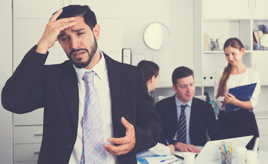 Business team with upset man foreground