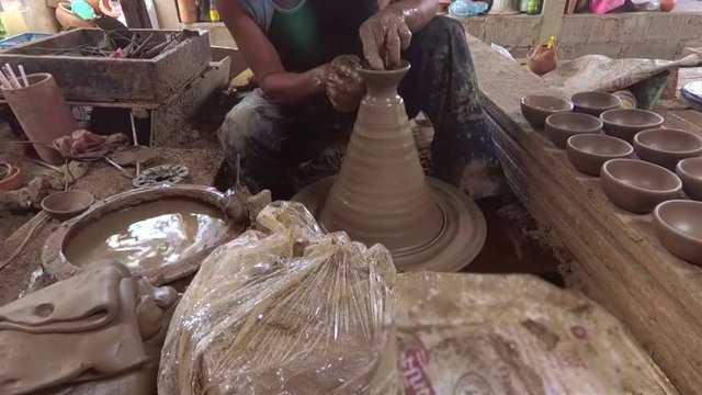 The potter is molding the clay pot
