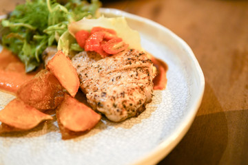 Pork steak in white disc.