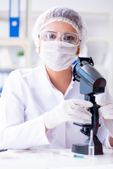 Female scientist researcher conducting an experiment in a labora