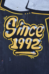 Texture of a fragment of the wall with graffiti painting, which is depicted on it. An image of a...