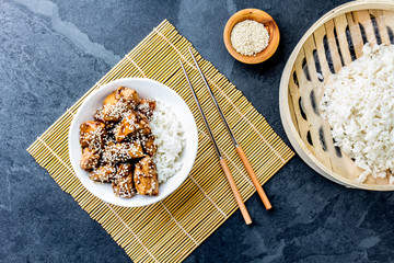 Japanese food. Chicken teriyaki with rice. slate background, top view