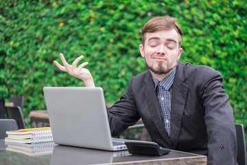 Looking for direction and inspiration, Portrait of happy young businessman sitting with laptop