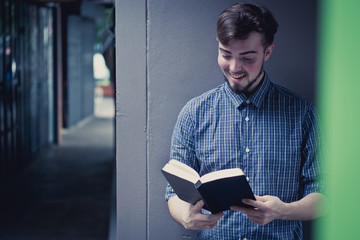 Closeup on a man holding a bible at shopping mall, believe concept