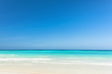 Beautiful gentle wave at the shallow beach with blue sky, Wonderful tropical beach for relaxation