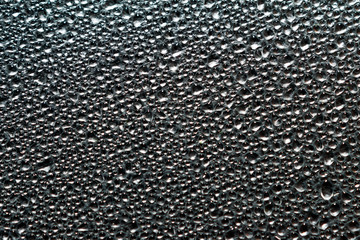 Abstract background of wet steam or water droplets on aluminum foil surface. Macro top view.