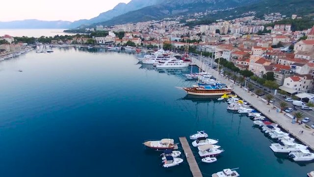 Aerial view on Makarska and marina at sunrise with Biokovo mountain in background. Makarska Riviera, Croatia 