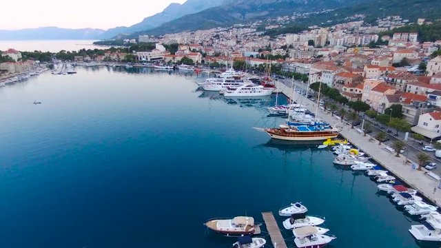 Aerial view on Makarska and marina at sunrise with Biokovo mountain in background. Makarska Riviera, Croatia 