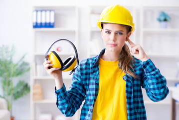 Woman in workshop with noise cancelling headphones