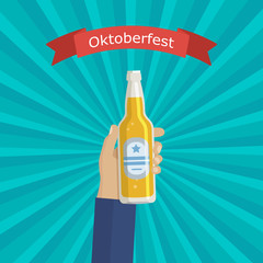 Hand holding bottle beer.