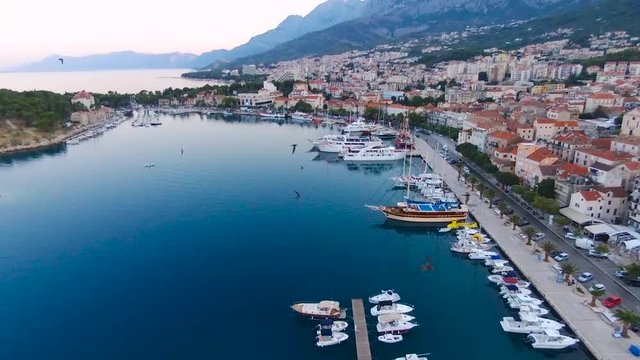 Aerial view on Makarska and marina at sunrise with Biokovo mountain in background. Makarska Riviera, Croatia 