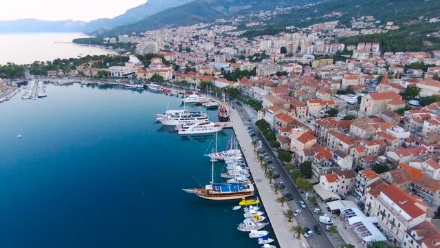 Aerial view on Makarska and marina at sunrise with Biokovo mountain in background. Makarska Riviera, Croatia 