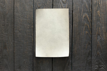 old paper on dark wooden wall