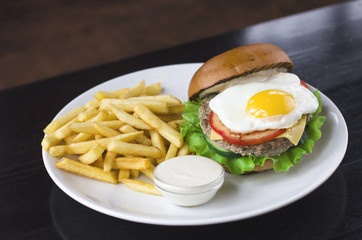 Meat Burger with egg, sauce and fries