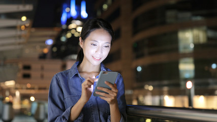 Young woman use of mobile phone at night