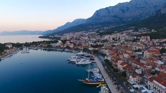 Aerial view on Makarska and marina at sunrise with Biokovo mountain in background. Makarska Riviera, Croatia 