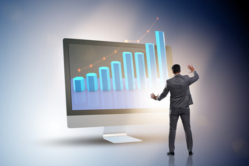 Businessman in economic forecasting concept with charts