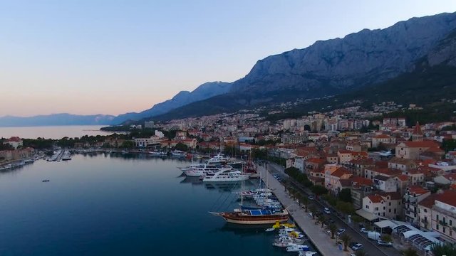 Aerial view on Makarska and marina at sunrise with Biokovo mountain in background. Makarska Riviera, Croatia 