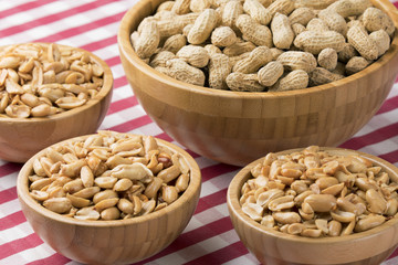 Bowls of fresh peanuts on a red checkered tablecloth
