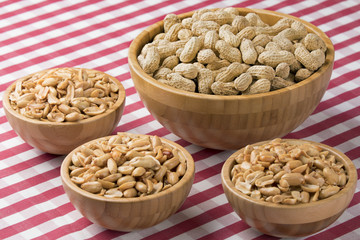 Bowls of fresh peanuts on a red checkered tablecloth