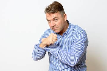 Middle aged man making a fist at the camera