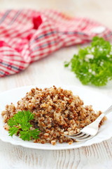 Buckwheat on a plate and fresh vegetables