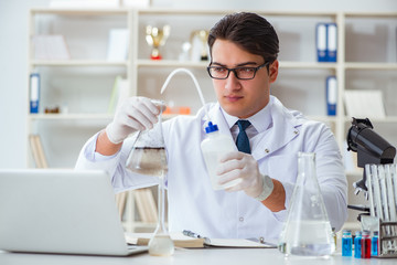 Young researcher scientist doing a water test contamination expe