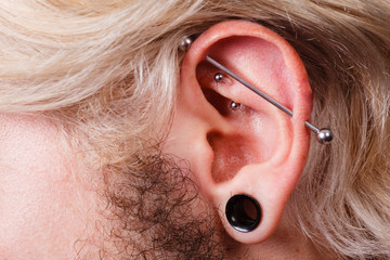 Pierced man ear, black plug tunnel, industrial and rook