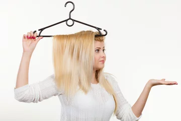 Foto auf Acrylglas Friseur Woman holding hair on clothes hanger