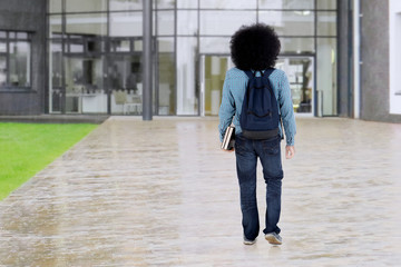 Afro student walks at school yard