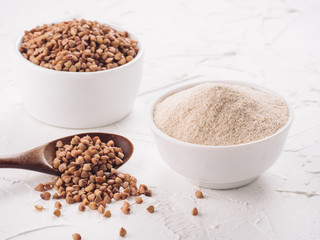 Buckwheat flour and buckwheat on white background