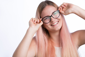 Young happy woman holding spectacles, looking away