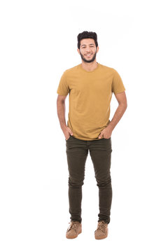 Handsome man wearing yellow T-shirt and green pants, guy smiling and standing confidently, isolated on white background