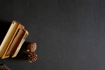 Top view vintage books on dark table.