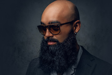 Arabic bearded shaved head male in sunglasses.