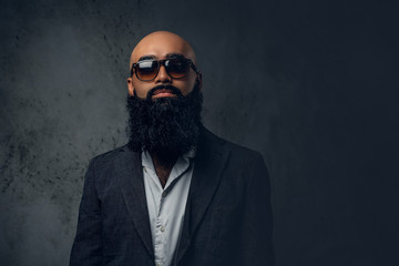 Bearded shaved head male in a suit.