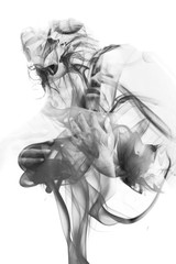 Black and white double exposure of a sexy interracial couple together with unpredictable swirls of smoke