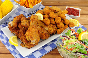 Collection of Southern fried chicken products with sweetcorn and salad