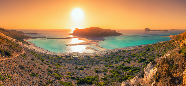 Amazing view of Balos Lagoon  at sunset with magical turquoise waters, lagoons, tropical beaches of pure white sand and Gramvousa island on Crete, Greece