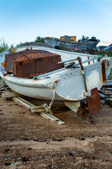 an old boat abandoned on a sandy beach
