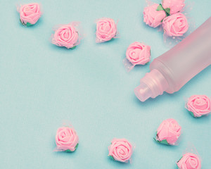 Perfume spray bottle and small pink roses