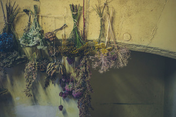 Herbs drying by fireplace