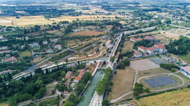 Aerial top view of Fonserannes locks on canal du Midi from above, unesco heritage landmark in France
