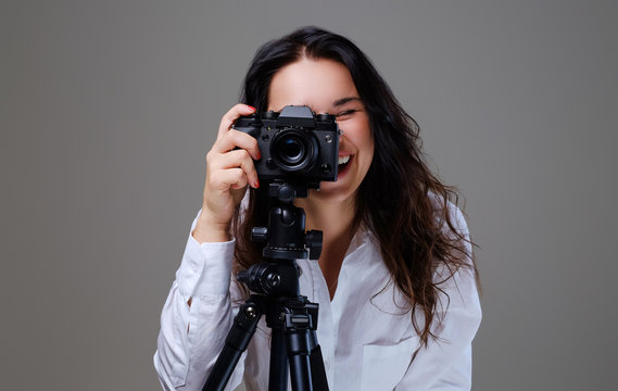 Female taking pictures with a professional photo camera.