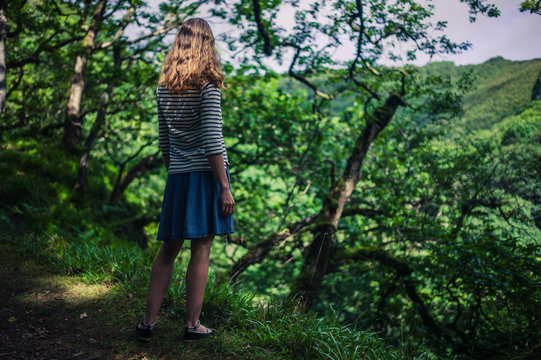 Young woman walking in the woods