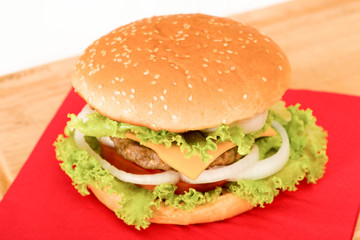 Home made hamburger with onion, tomato, lettuce, cheese . close-up